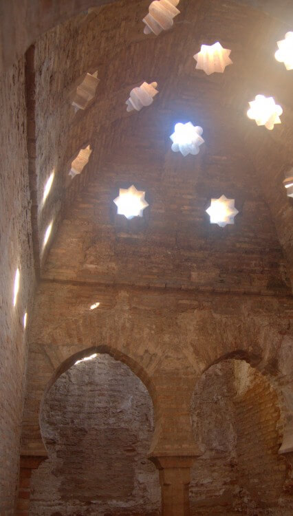 Bath house with a fancy steam venting roof.