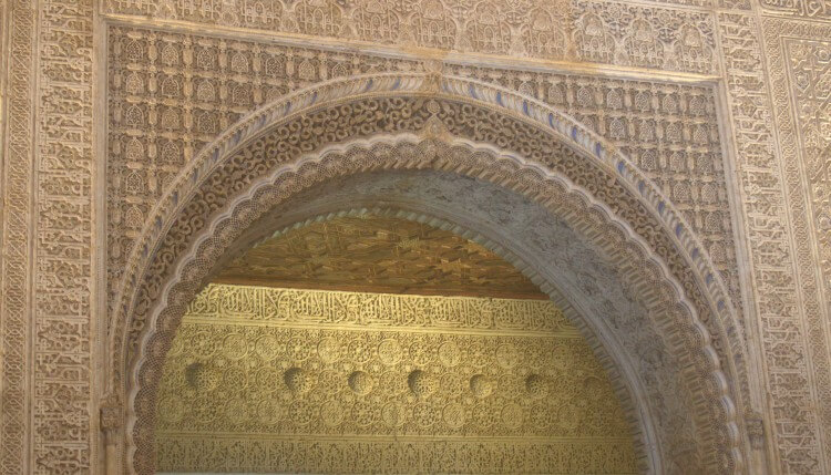 Carved walls and arches in the Nasrid Palace.