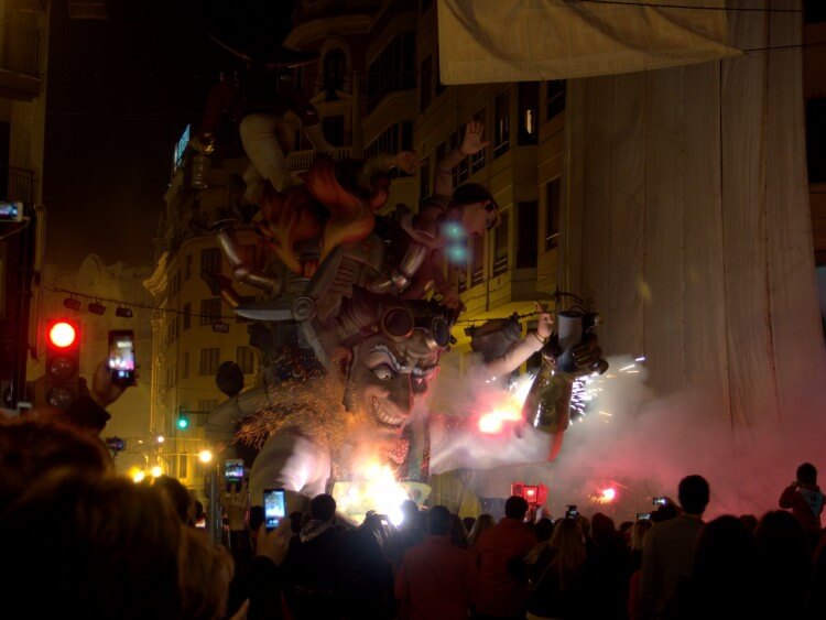 The sculpture is set on fire with fireworks.