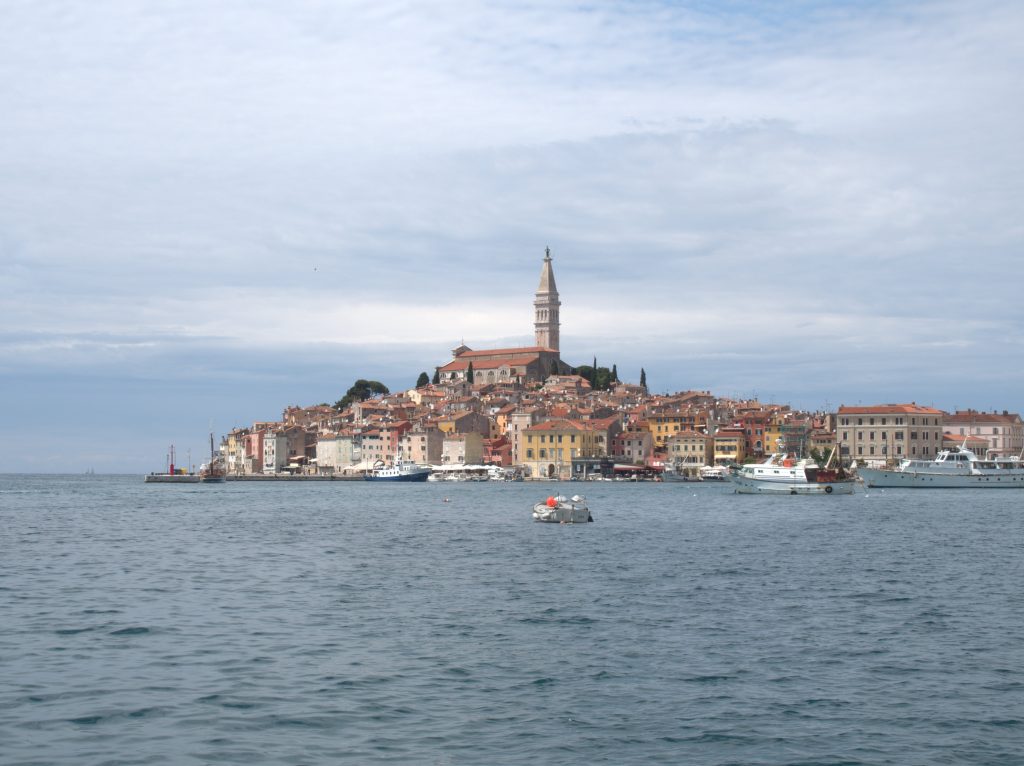 Rovinj with the cathedral and belltower on the top of the town.