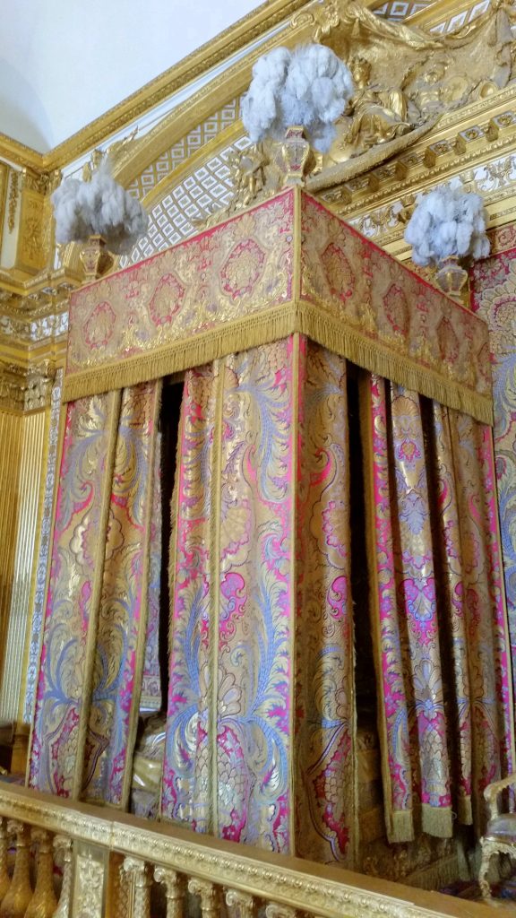 The ridiculously extravagant bed of Louis XIV. He loved pomp and ceremony so much that he had special 'waking up' and 'going to bed' ceremony everyday where only special people were invited to watch.