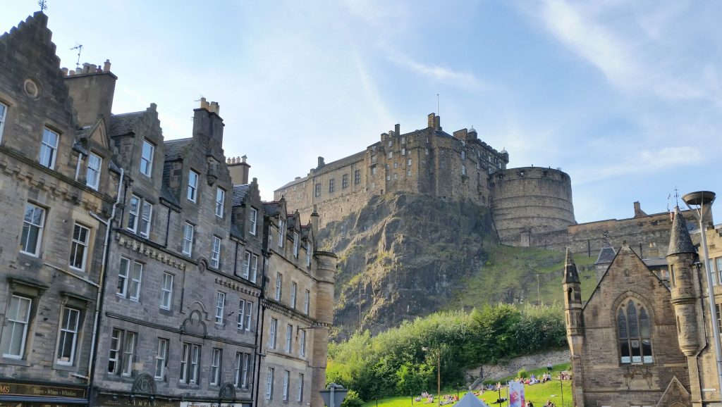 Old stone buildings of the Grassmarket with the castle watching over everything.
