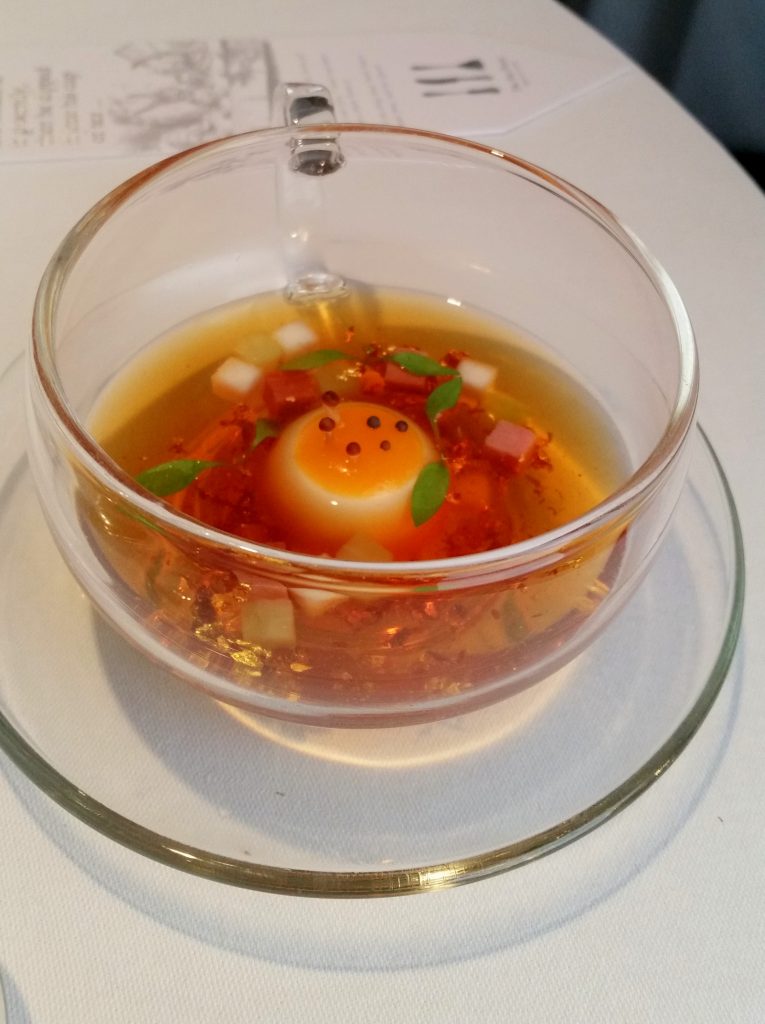 Mock turtle soup inspired by Alice in Wonderland. To make the broth for this you put a gold pocket watch into a teapot of hot water and then it dissolves, then you pour the tea into the teacup and you have soup!