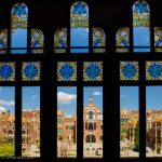 Looking through stained glass windows to the buildings of Sant Pau Hospital in Barcelona.