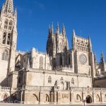 A pilgrim stops outside Burgos Cathedral along the Camino pilgrimage to Santiago de Compostela.