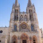 Two women enter Burgos Cathedral to pray.