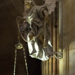 An angel in Cádiz Cathedral holding a lantern.