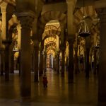 A small child lost in the endless forest of columns in Córdoba's Mezquita.