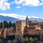 A picture of the Alhambra palace with it's fortifications, and the snow-covered Sierra Nevada mountains rising behind it.