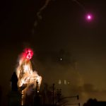 As this sculpture begins to burn, a pink flare is launched from its head.