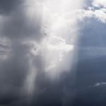 A picture of the sun's rays breaking through rain clouds.