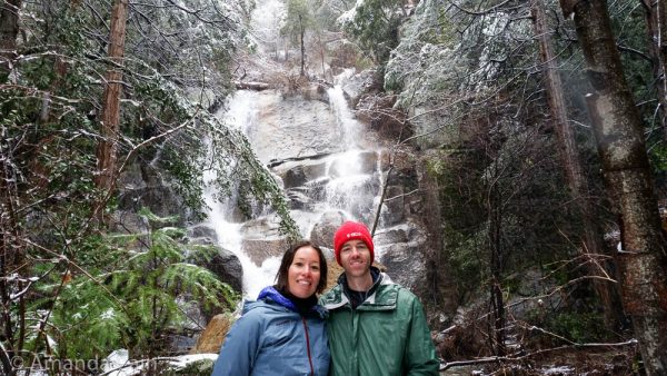 A picture of Amanda and Pedr standing in front of a waterfall.