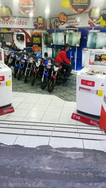 A motorbike and TV shop in Quito.