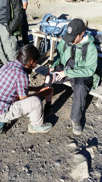 Pedr getting first aid after straining his knee.