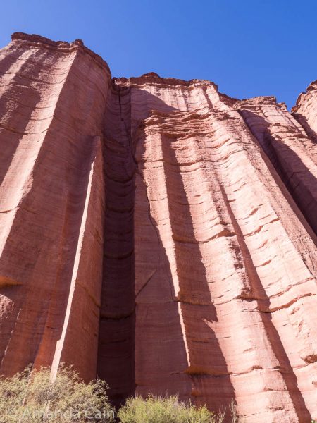 All along the canyon you have these semi-circular chimneys cut out of the cliff side. The deep one in shadow is perfect for reflecting echoes.