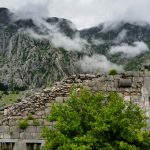 Ruined fortifications of Kotor with the imposing mountains behind.