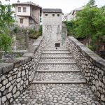 A lone pigeon crossing the Crooked Bridge.