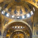 The inside of St Mark's Cathedral is covered in golden mosaics.