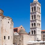 A young boy rides his bike through the ruins of the Ancient Roman forum in Zadar.