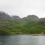 Brightly coloured houses dwarfed by the spectacular Norwegian fjords.