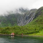 In the northern fjords of Norway you occasionally see houses dotted around in between giant mountains and waterfalls.