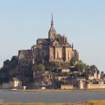 Mont Saint-Michel rising out of the bay at sunrise.