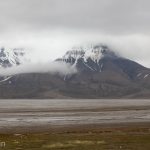 Mountains of Svalbard shrouded in clouds.