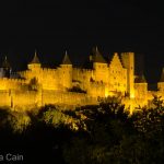 The fairy tale castle of Carcasonne lit up at night.