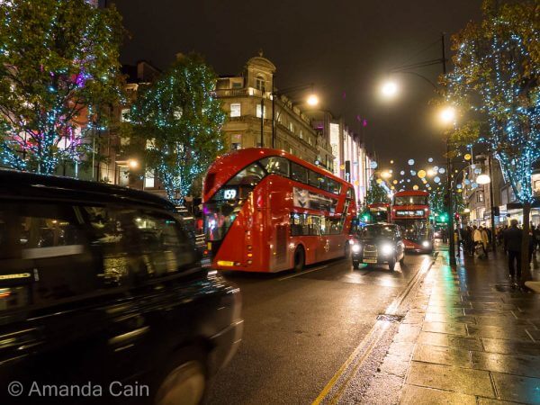 Christmas lights, London cabs and double decker buses on Oxford Street.