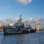 A modern warship against the old Tower of London and Tower Bridge.