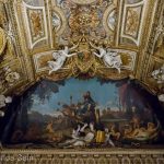 The richly decorated ceiling in the Apollo Gallery of the Louvre Museum.