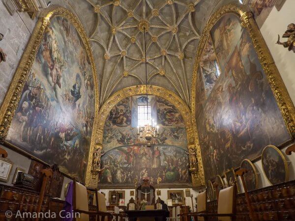 Inside the cathedral sacristy the walls are covered in huge paintings.