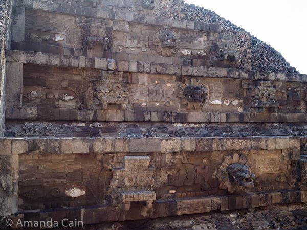Mythical figures peering out from the Temple of the Feathered Serpent in Teotihuacan.