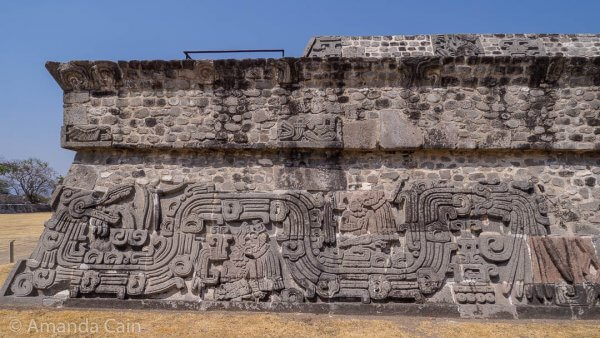 The feathered serpent and seated rulers along the side of the Temple of the Feathered Serpent.
