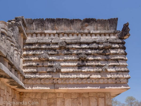 The top of this building is designed to look like a thatched roof with birds all over it.
