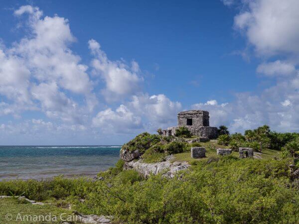 The Temple of the Wind God perched high on a cliff. You can see some small mini-temples nearby.